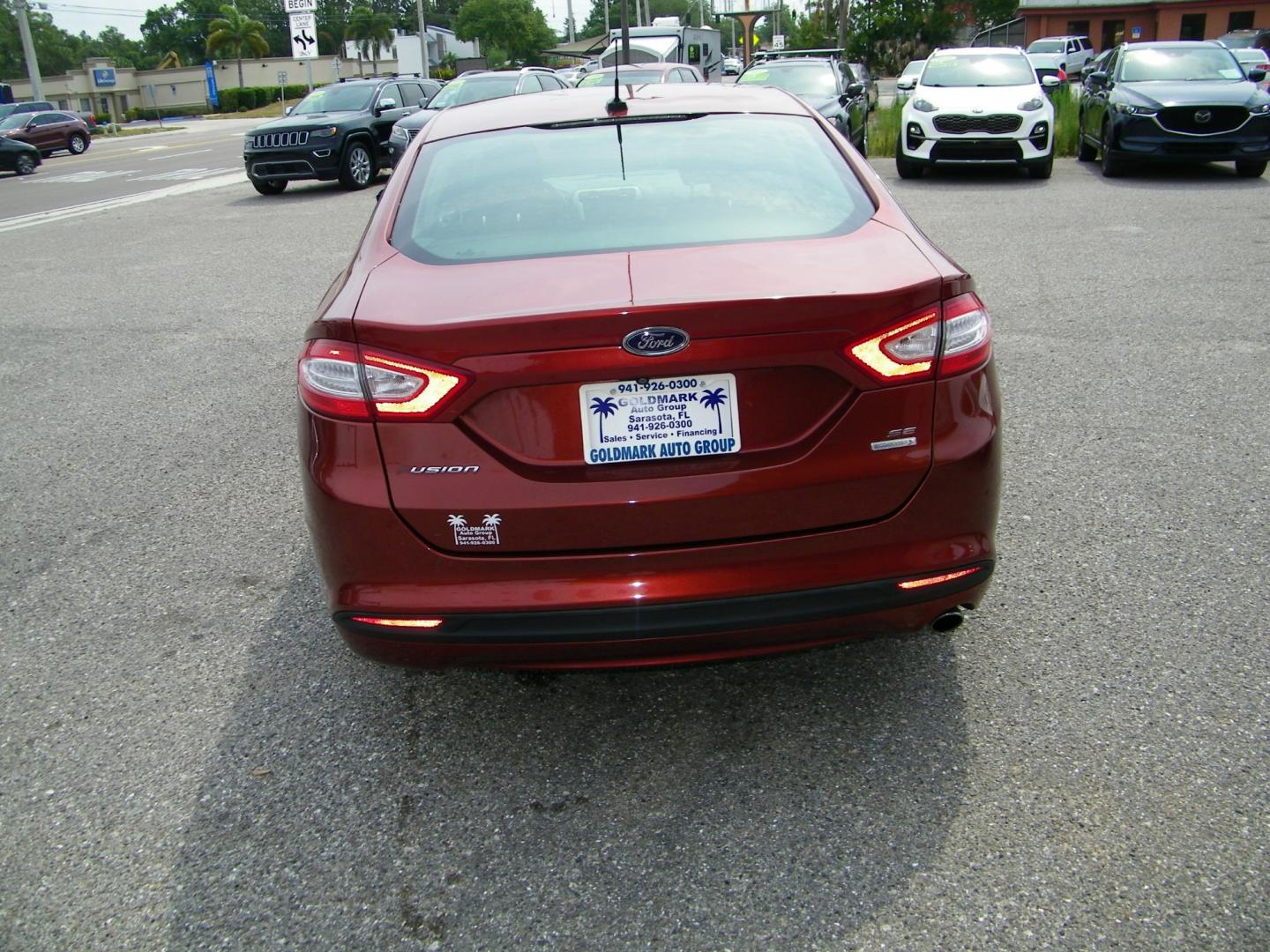 2014 Orange /Black Ford Fusion SE (3FA6P0HD7ER) with an 1.5L L4 DOHC 16V engine, Automatic transmission, located at 4000 Bee Ridge Road, Sarasota, FL, 34233, (941) 926-0300, 27.298664, -82.489151 - Photo#4